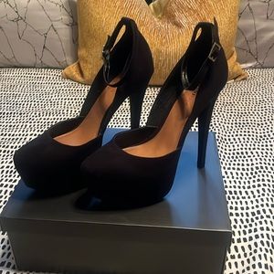 JustFab Danika Black platform with strap and gold buckle.